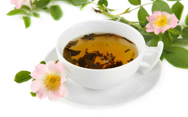Cup of herbal tea with hip rose flowers, isolated on white