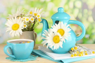Beautiful bouquet chamomiles in teapot