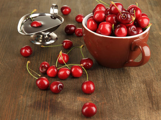 Ripe red cherry berries in cup and chocolate sauce