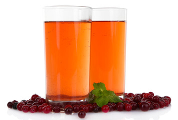 Glasses of cranberry juice and ripe red cranberries, isolated