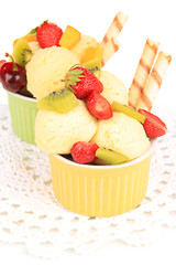 Delicious  ice cream with fruits and berries in bowl close up