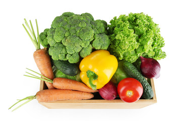 Fresh vegetables in wooden box on grey background