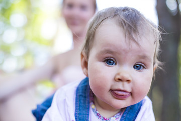 Small pretty baby showing a tongue