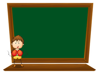 A boy in front of the empty blackboard