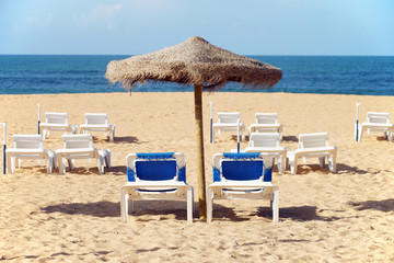 Beach with sunbeds and umbrella