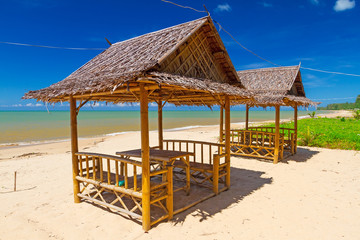 Tropical beach scenery with small huts in Thailand