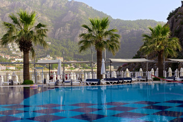 Obraz na płótnie Canvas Palm trees at swimming pool