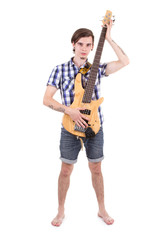 Young rocker standing with bass guitar
