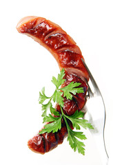 Grilled sausage on a fork.