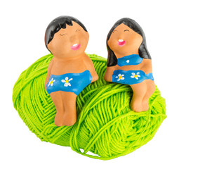 doll on green yarn