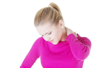 oung woman holding hand on her neck.
