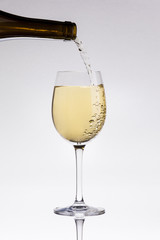 Pouring white wine in a glass