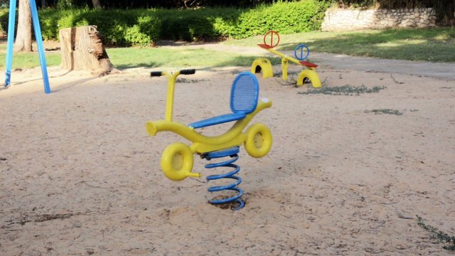 Outdoor playground bicycle in motion up and down