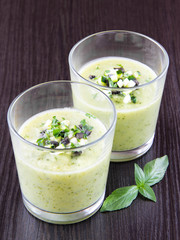 Vegetable cream soup with avocado, herbs, zucchini and black oli
