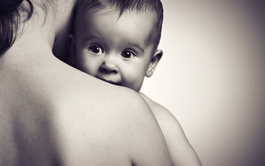 cute baby at hands of the mother in an embrace, monochrome