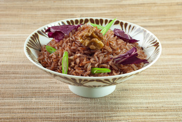 Cooked red rice with topping