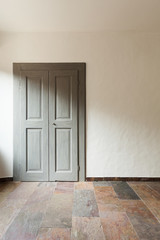 closed door in a rustic house, stone floor