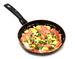 scrambled eggs with sausage in a frying pan 