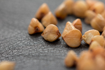 Obraz premium Buckwheat on black skin. macro