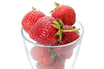 Fresh strawberries and glass isolated on white background