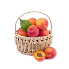 fresh apricot in wicker basket isolated on white
