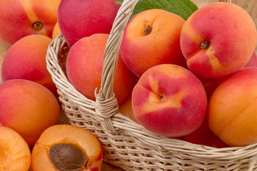 Naklejka na ściany i meble fresh apricot in wicker basket in close up
