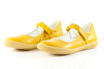 Children's shoes isolated over the white background.  yellow  sh