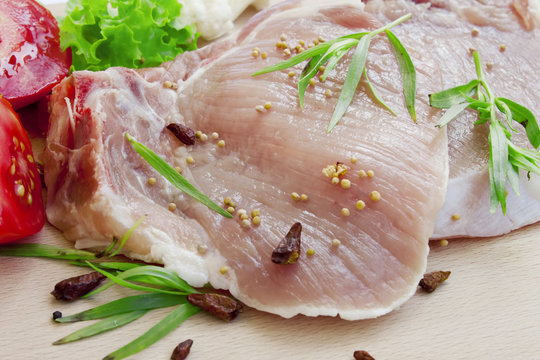 Raw pork chop fillets with spices
