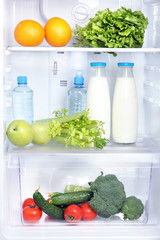 Open refrigerator with vegetarian food © Africa Studio