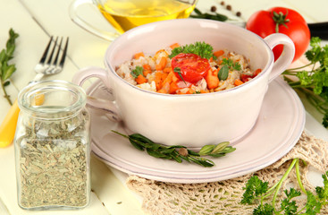 Delicious rice with vegetables and herbs in pot