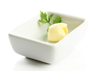 Butter curl on plate, isolated on white