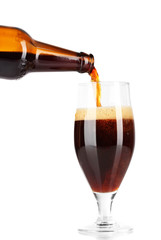 Beer poured into glass isolated on white
