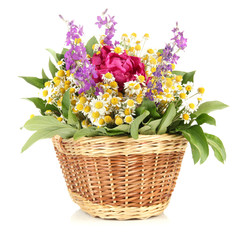 Bouquet of wild flowers in wicker basket, isolated on white