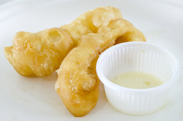 deep-fried doughstick on white plate
