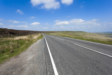 Fototapeta na wymiar Rural A640 road running through rugged Yorkshire Moorland