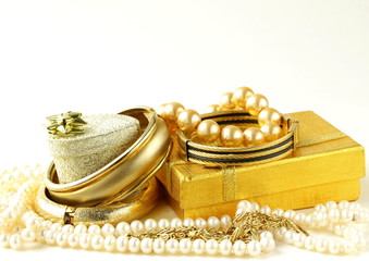 gold and pearl jewelry, gift boxes on a white background © Olga Kriger
