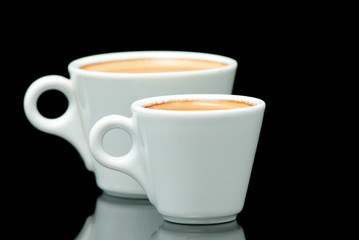Fototapeta na wymiar two white coffe cups on the black background