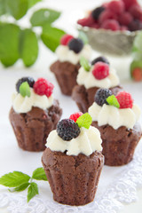 Chocolate muffins with raspberries and cream.