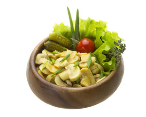 Marinated mushrooms in white saucer isolated on white