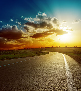 Fototapeta perfect sunset over asphalt road
