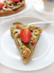 homemade cake with strawberries, rhubarb and cashew nuts
