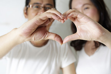 romantic couple making heart shape