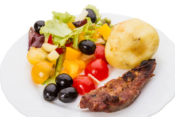 Vegetable salad with olives and meat