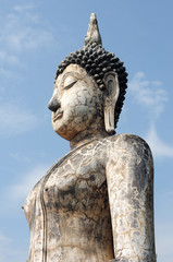 Fototapeta na wymiar Statue of a deity in the Historical Park of Sukhothai