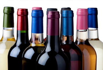 Some wine bottles in front of white background