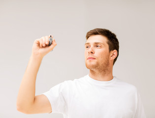 man writing something in the air