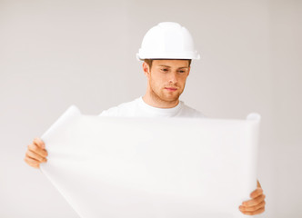 male architect looking at blueprint
