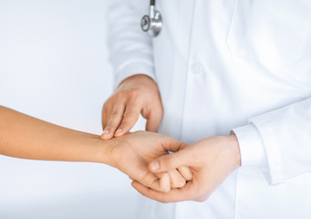 doctor measuring patient heart beat