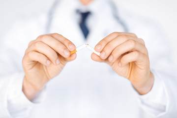 man breaking the cigarette with hands