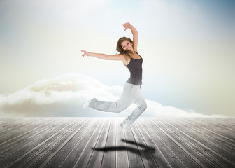 Fototapeta na wymiar Woman jumping over wooden boards
